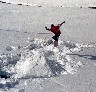 One day during the winter of 2000, we headed off to Spray Lakes to go kiteskiing. We found three things:   No wind.   The lake was about 20 feet below the road alongside it.   There was about five feet of fresh powder everywhere.  The first guy to get there had taken advantage of this and built a small kicker at the bottom of the slope. While normally I'm relatively wussy about jumps, the huge piles of fluffy powdery snow made it next to impossible to hurt myself.. 